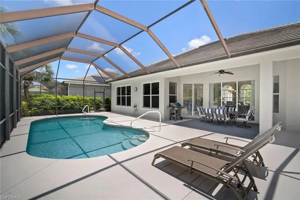 a view of a patio with table and chairs