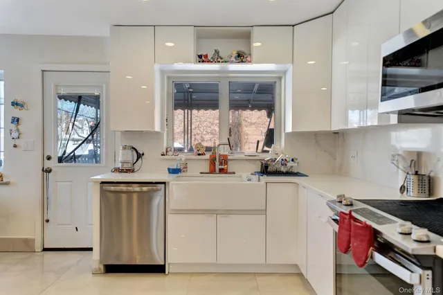 a kitchen with stainless steel appliances kitchen island granite countertop a refrigerator a stove a sink dishwasher with a dining table and chairs