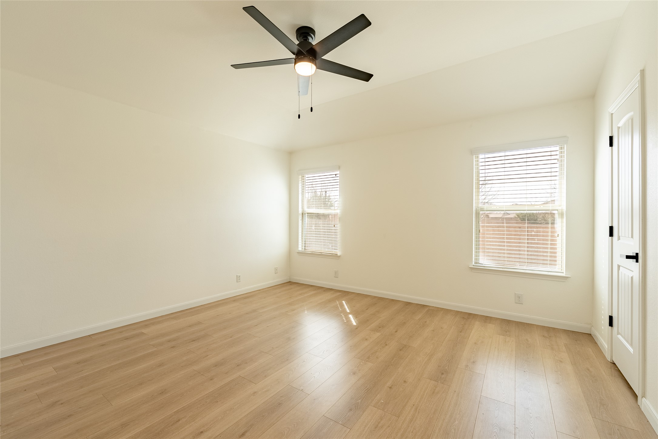 1437 April Meadows Loop Georgetown, TX 78626 - Photo 13 of 31 an empty room with wooden floor fan and windows