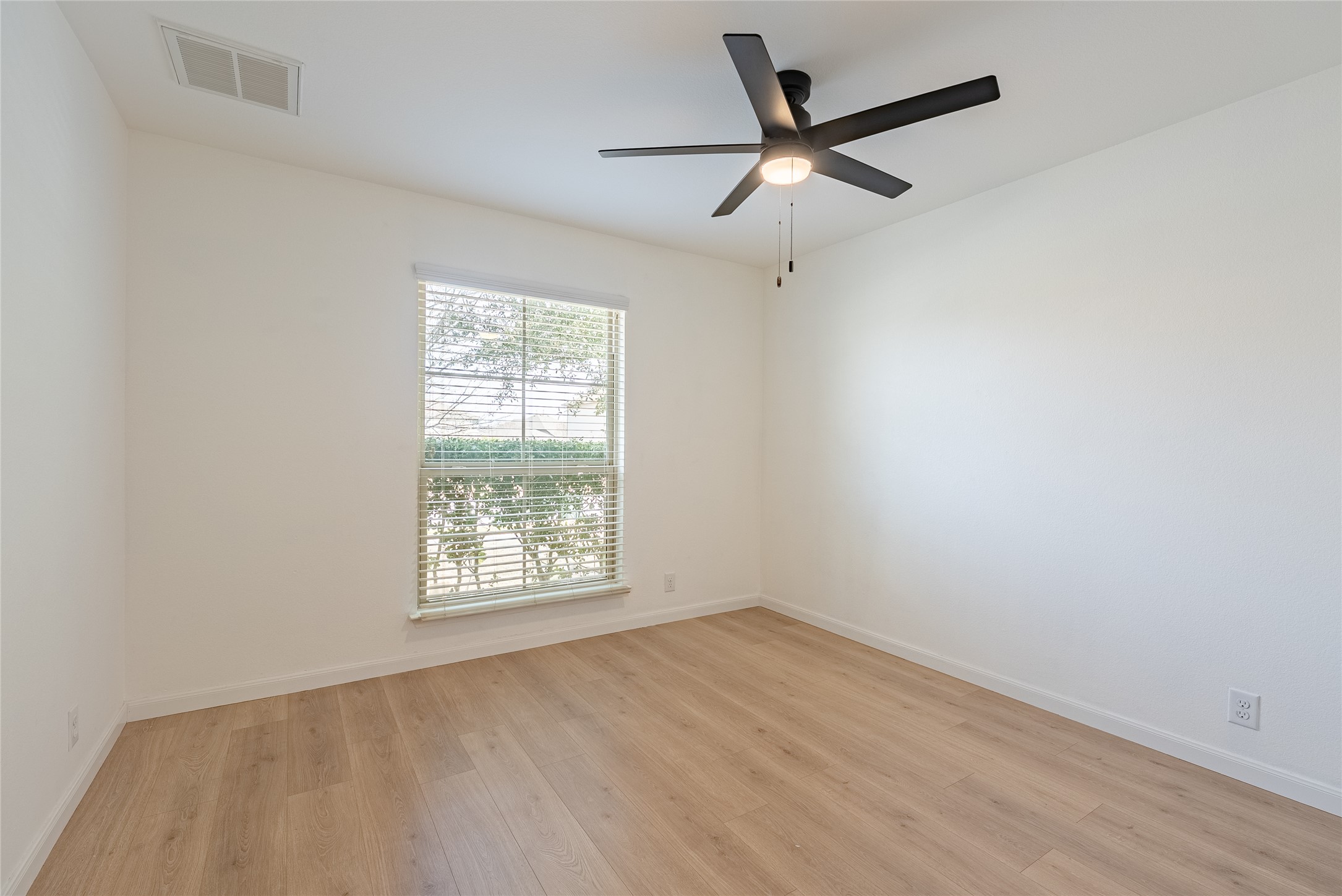 1437 April Meadows Loop Georgetown, TX 78626 - Photo 17 of 31 an empty room with a window and a ceiling fan