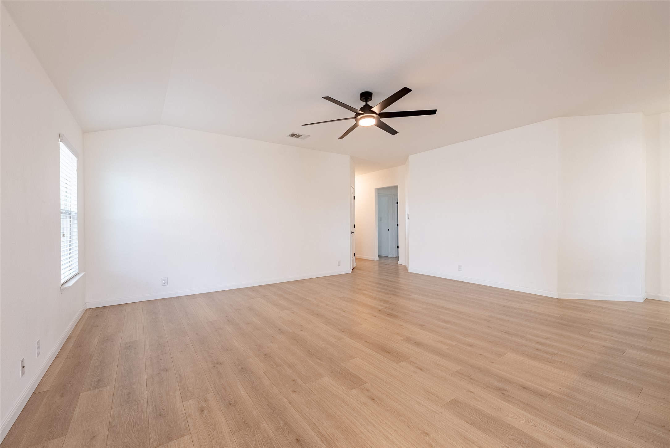1437 April Meadows Loop Georgetown, TX 78626 - Photo 7 of 31 a view of room with wooden floor and ceiling fan