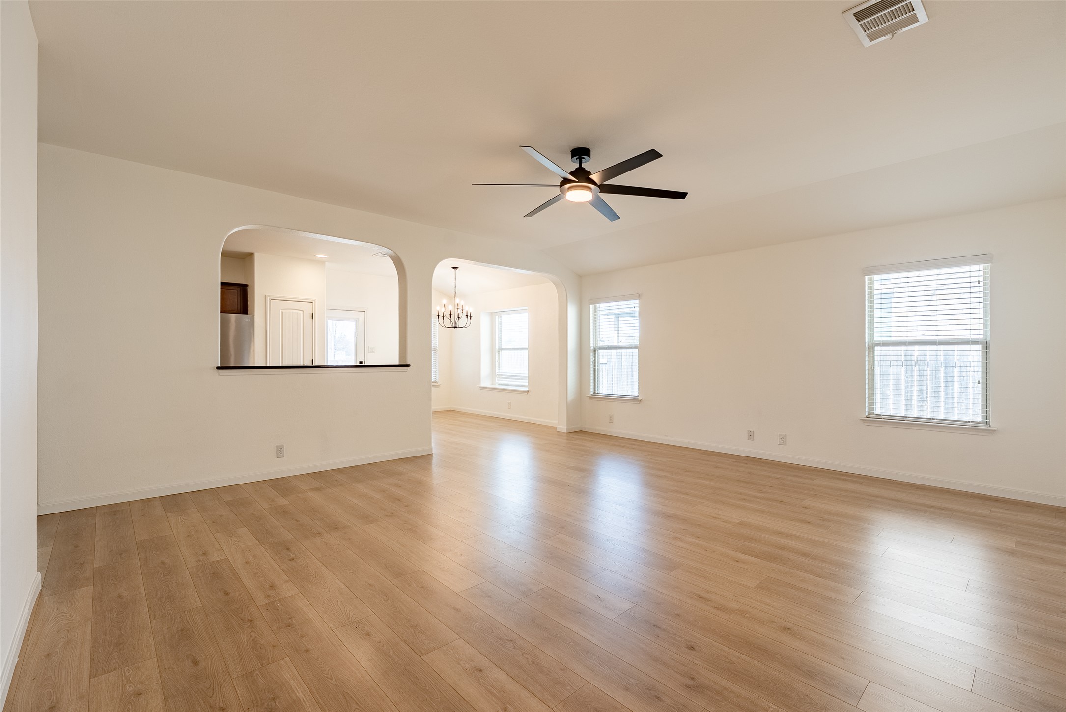 1437 April Meadows Loop Georgetown, TX 78626 - Photo 8 of 31 a view of empty room with wooden floor and fan