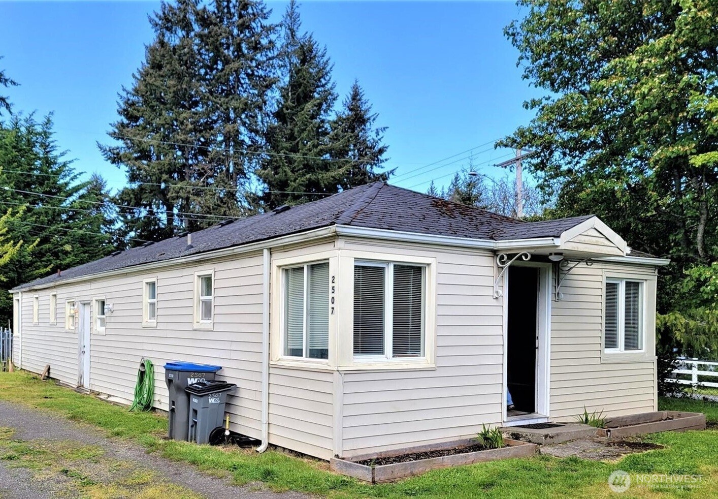 2507 Erlands Point Road Northwest Bremerton, WA 98312 - Photo 2 of 8 a front view of a house with garden