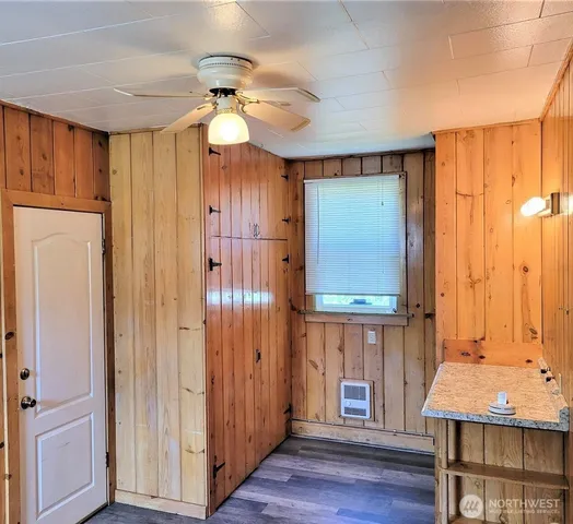 a view of a bathroom with a bathtub a chandelier and wooden floor