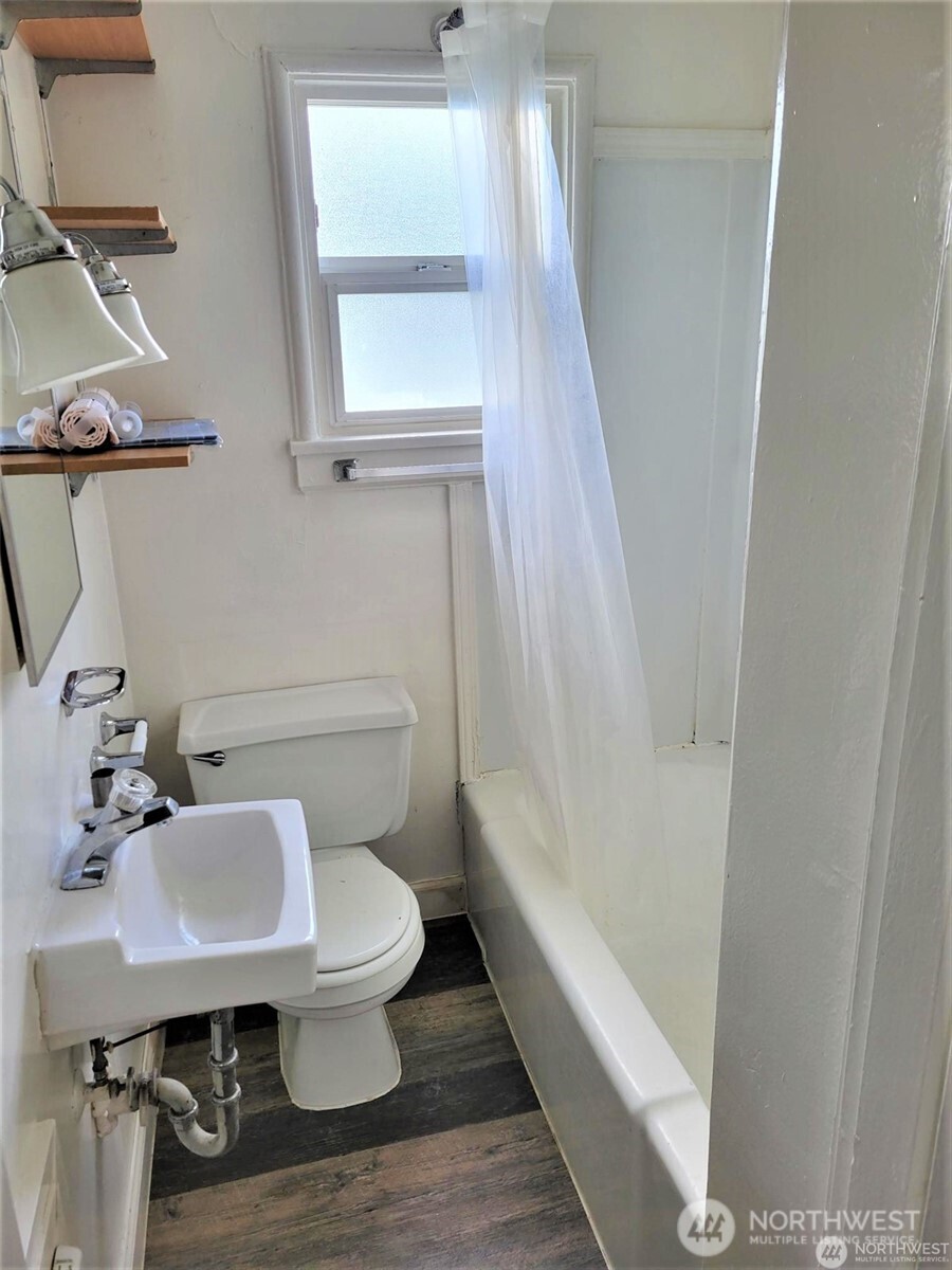 2507 Erlands Point Road Northwest Bremerton, WA 98312 - Photo 8 of 8 a white toilet sitting next to a bathroom sink