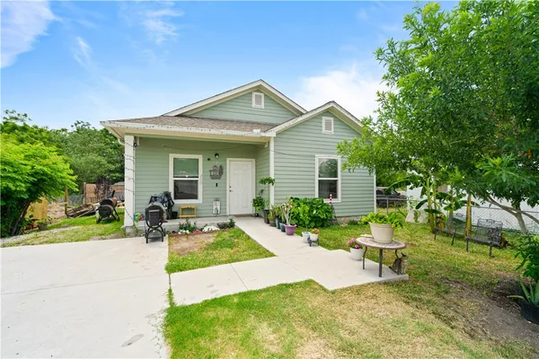 a front view of a house with a yard and porch