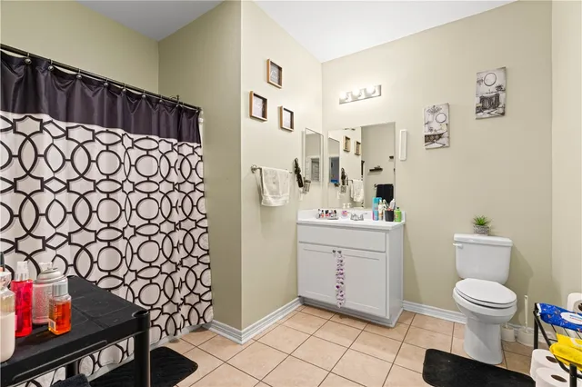 a bathroom with a toilet and a shower curtain