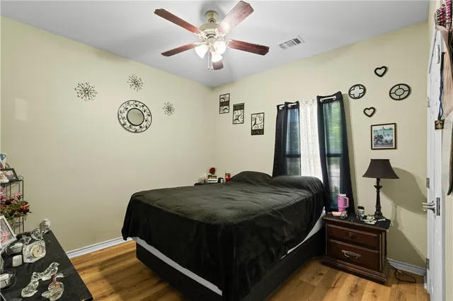 a bed sitting in a bedroom next to a window