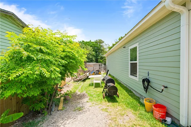 a view of backyard with plants and a patio