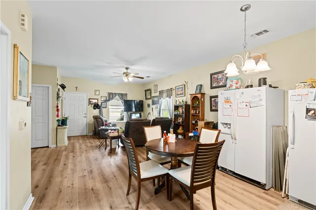 a dining room with furniture and wooden floor