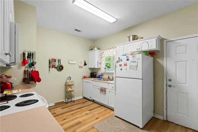 a white refrigerator freezer sitting inside of a kitchen