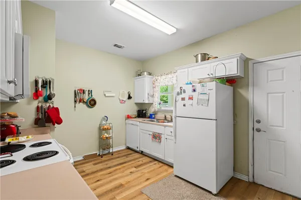 a white refrigerator freezer sitting inside of a kitchen
