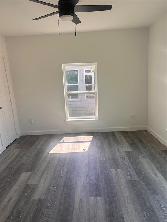 824 North Virginia Street Terrell, TX 75160 - Photo 11 of 21 an empty room with wooden floor and windows