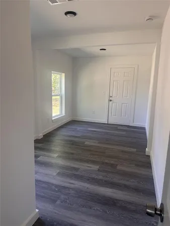 a view of wooden floor and windows in a room