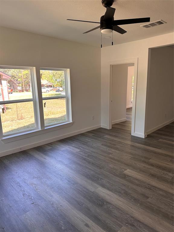 824 North Virginia Street Terrell, TX 75160 - Photo 5 of 21 a view of an empty room with wooden floor and a window