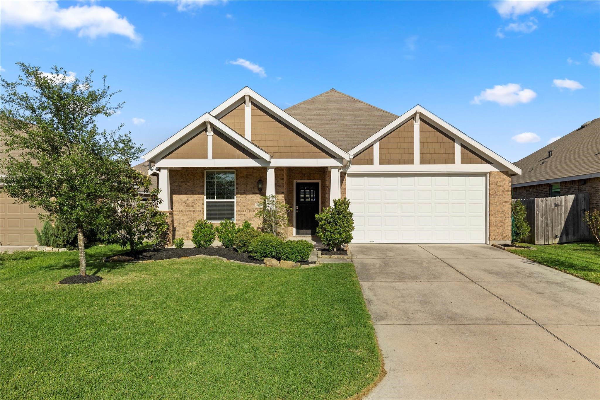 29507 Whitebrush Trace Drive Spring, TX 77386 - Photo 30 of 32 Front exterior view with attached two-car garage and landscaped entry.