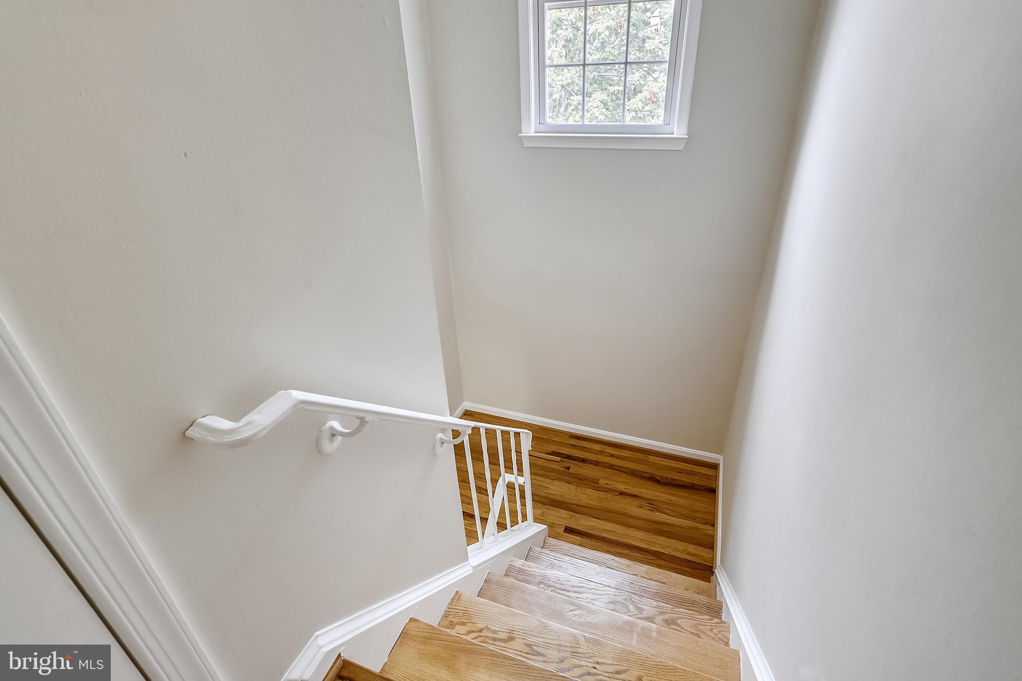 7025 Leebrad Street Springfield, VA 22151 - Photo 20 of 32 Stairs illuminated by sunlight.