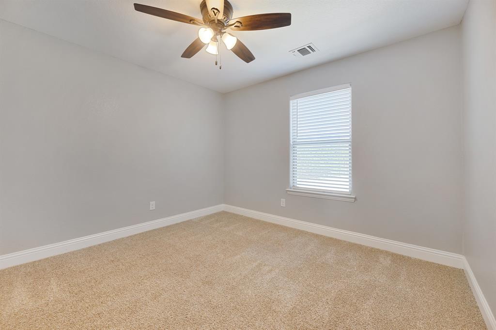 1713 Bronco Road Granbury, TX 76049 - Photo 19 of 23 Spacious room with plush carpeting, neutral wall finishes, and white baseboards
