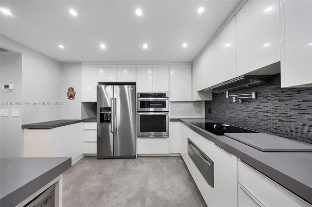 a kitchen with a sink stainless steel appliances and cabinets