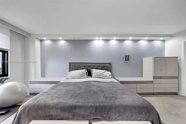 a bedroom with a bed and a large mirror