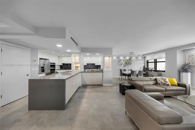 a living room with furniture and a kitchen