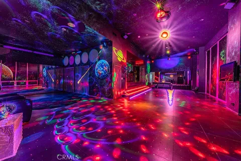 a view of an entryway with a dining table and chairs