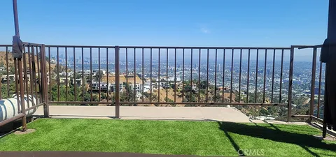 a view of a chair and tables in the balcony