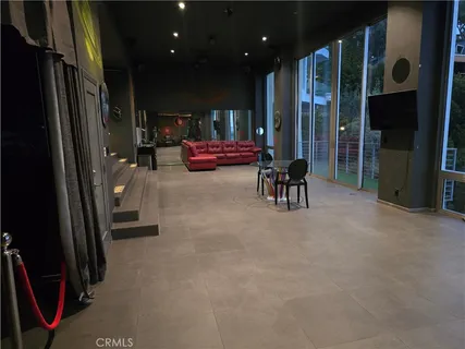 a living room with furniture and a glass door