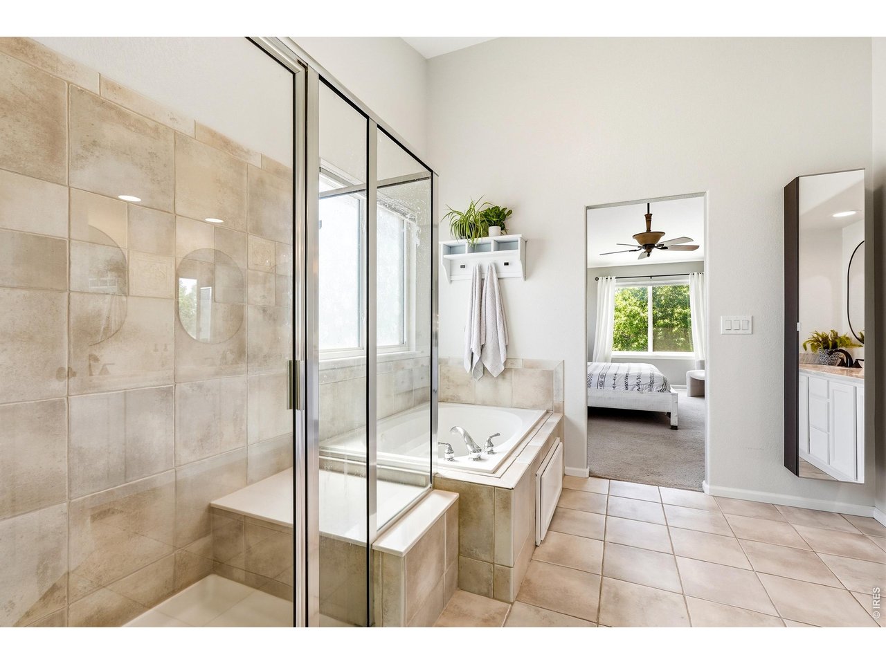 11725 Pleasant Hill Road Longmont, CO 80504 - Photo 29 of 50 Beautifully updated primary bathroom with dual vanity, soaking tub, glass and tile shower, private water closet, and an impressive walk-in closet