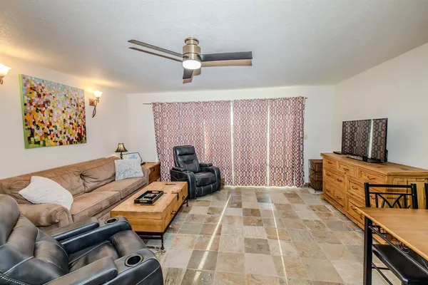 a living room with furniture and kitchen view