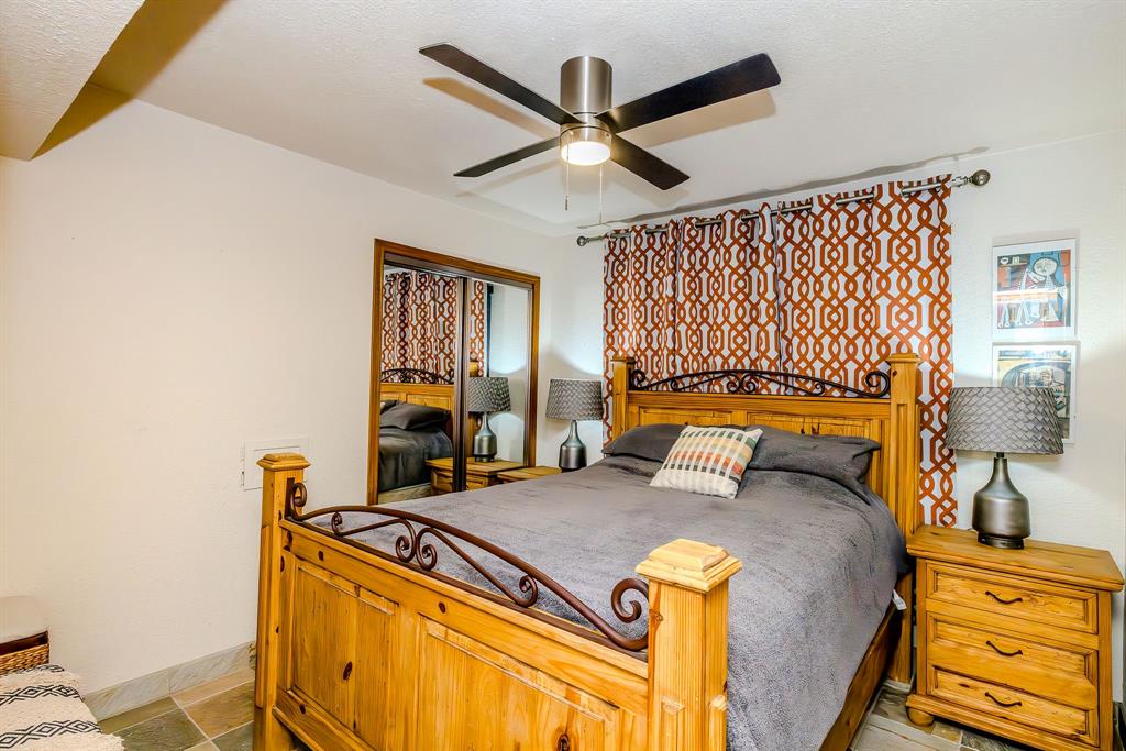1655 Cedar Crest Loop, Unit E7 Graford, TX 76449 - Photo 14 of 35 a bedroom with a bed and wooden floor