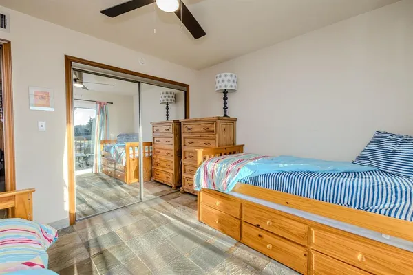 a bedroom with a bed and a large window