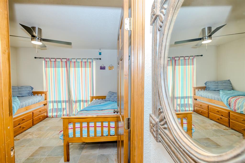 1655 Cedar Crest Loop, Unit E7 Graford, TX 76449 - Photo 25 of 35 a view of a bedroom with furniture and staircase