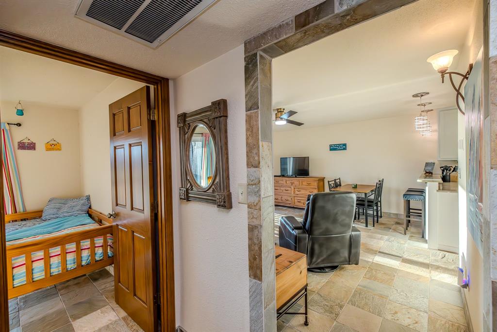 1655 Cedar Crest Loop, Unit E7 Graford, TX 76449 - Photo 26 of 35 a dining room with furniture and a mirror