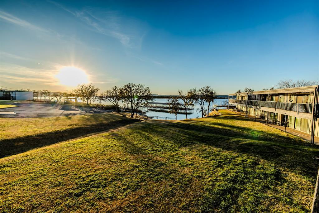 1655 Cedar Crest Loop, Unit E7 Graford, TX 76449 - Photo 5 of 35 a view of a lake with houses