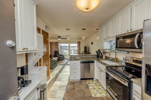 a kitchen with a sink stainless steel appliances and cabinets