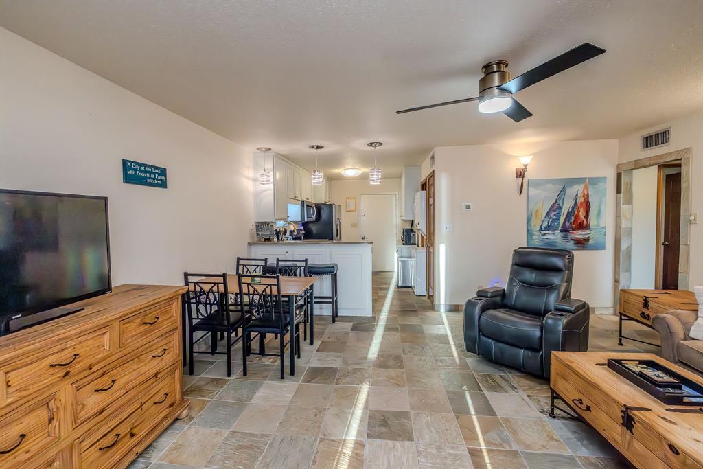 1655 Cedar Crest Loop, Unit E7 Graford, TX 76449 - Photo 35 of 35 a living room with furniture and a flat screen tv