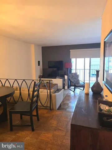 a living room with furniture and a floor to ceiling window