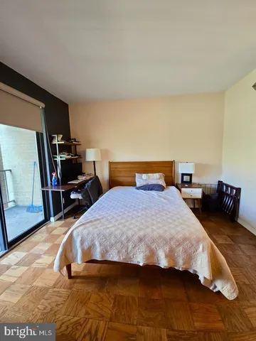 a bedroom with a bed and a couch