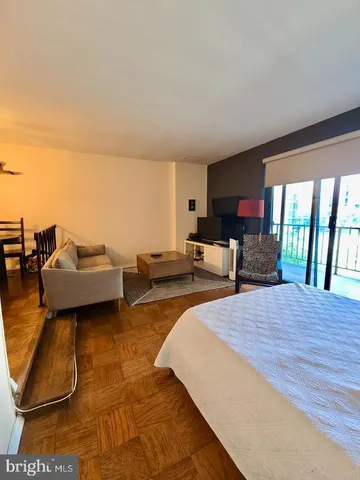 a living room with furniture and a floor to ceiling window