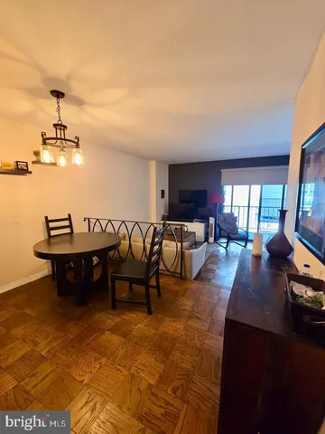 a view of a dining room with furniture and chandelier