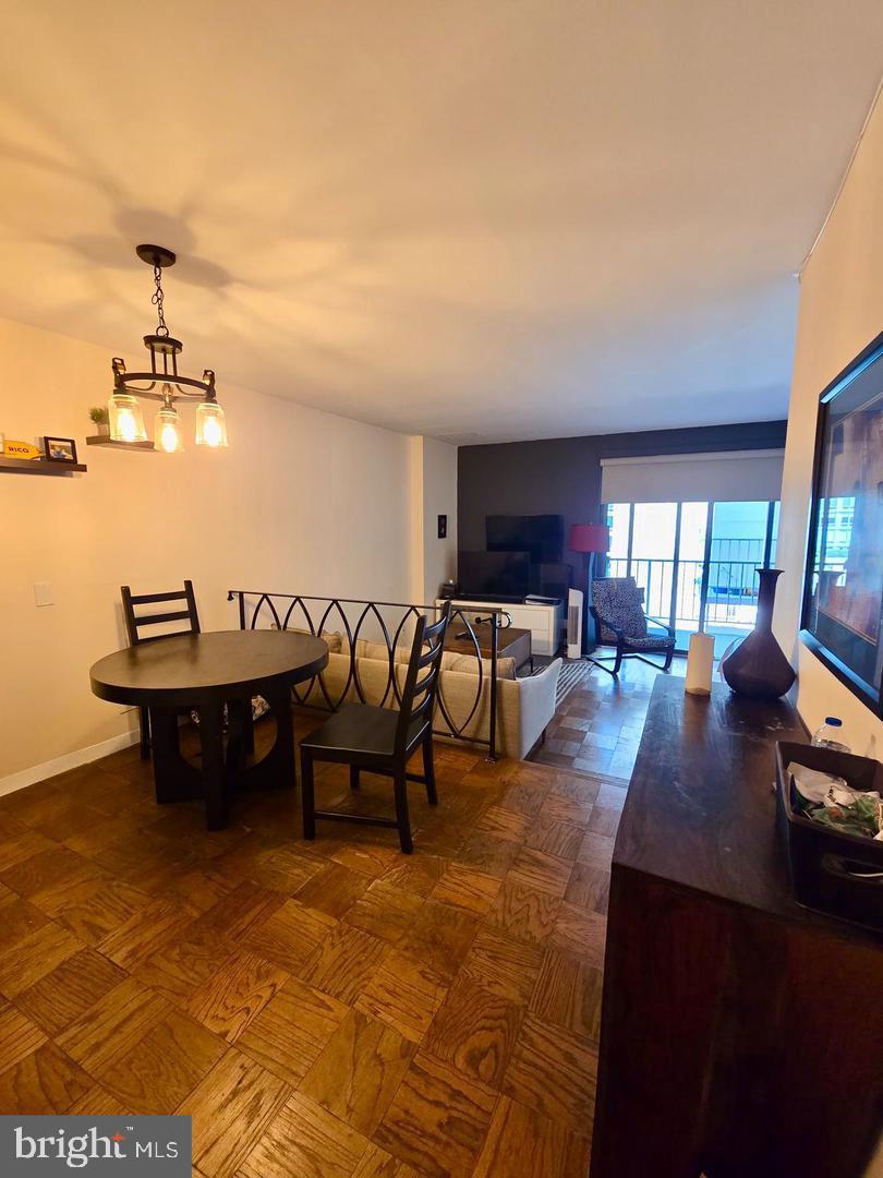 2201 L Street Northwest, Unit 820 Washington, DC 20037 - Photo 6 of 7 a view of a dining room with furniture and chandelier