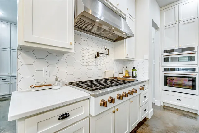 a kitchen with granite countertop a stove and a sink