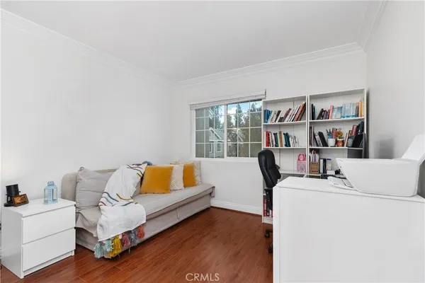 a living room with furniture and a book shelf