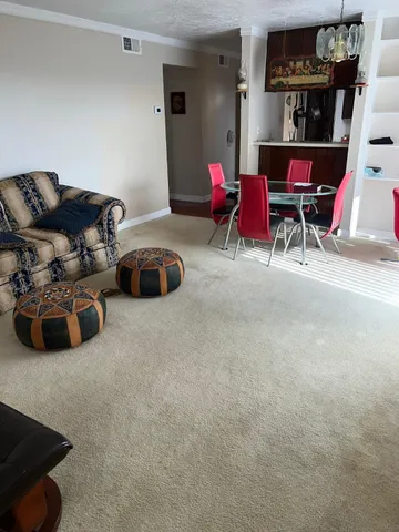 a living room with furniture and gym equipment