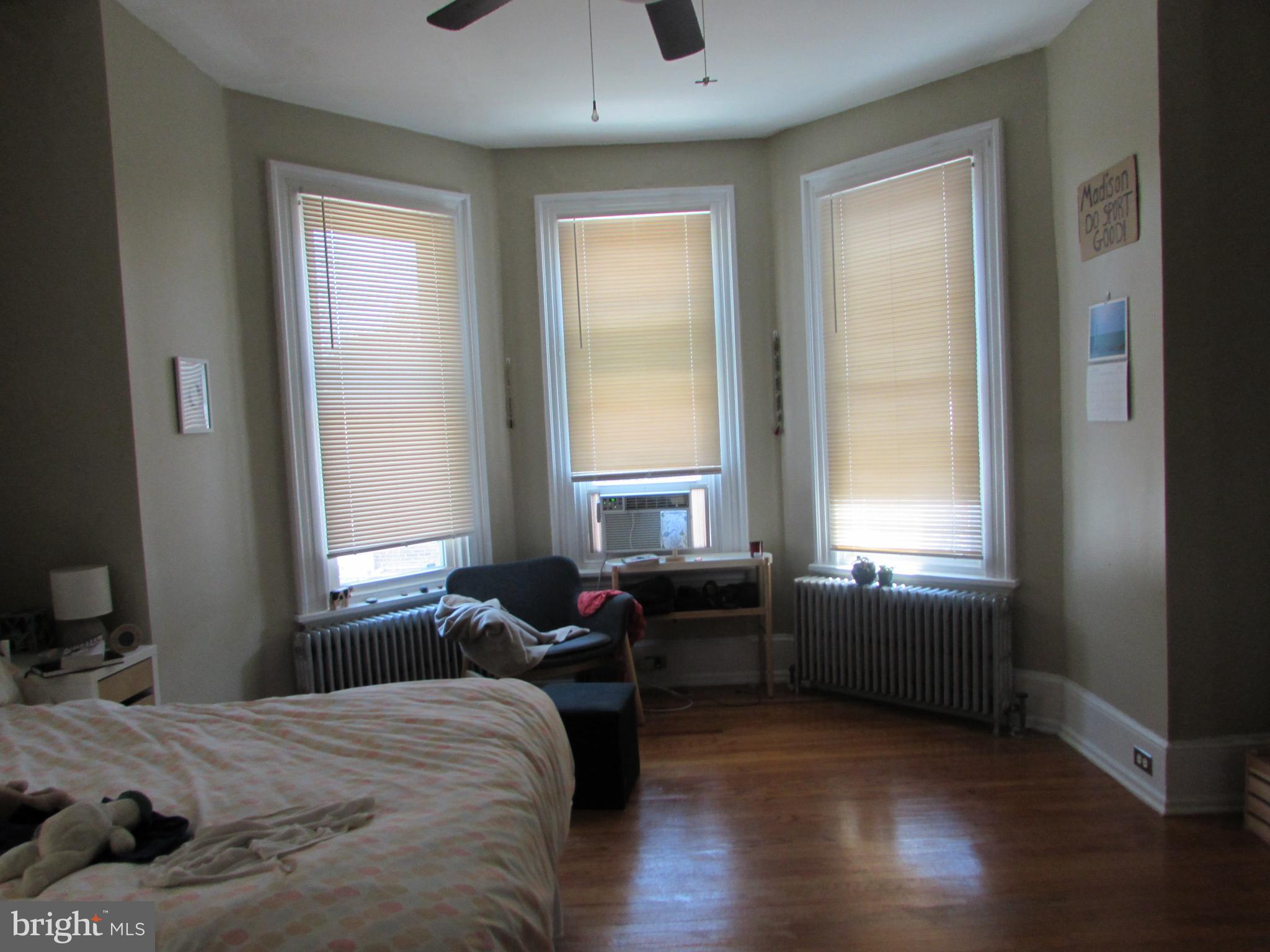 5903 Greene Street Philadelphia, PA 19144 - Photo 2 of 14 a bedroom with a bed and wooden floor