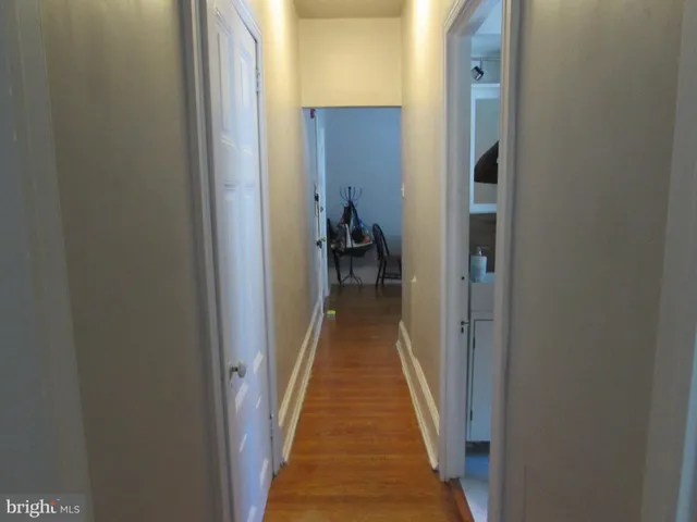 a view of a hallway with a livingroom and a hallway