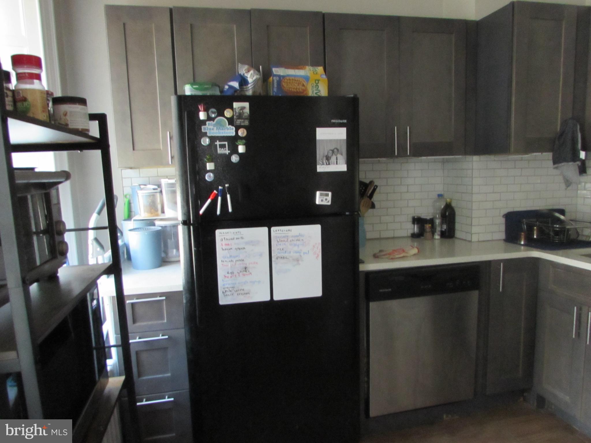 5903 Greene Street Philadelphia, PA 19144 - Photo 10 of 14 a kitchen with stainless steel appliances kitchen island granite countertop a refrigerator