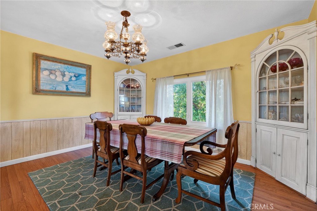 10079 West Lilac Road Escondido, CA 92026 - Photo 13 of 50 a view of a dining room with furniture window and wooden floor