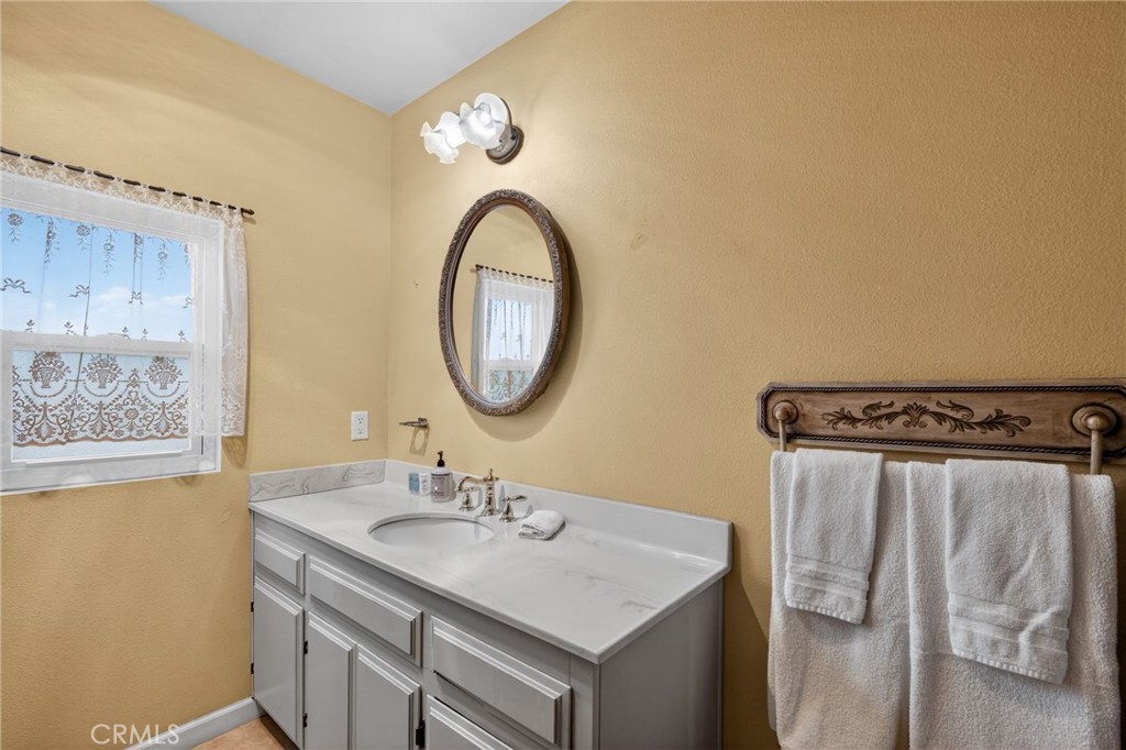 10079 West Lilac Road Escondido, CA 92026 - Photo 16 of 50 a bathroom with a sink vanity mirror and a mirror